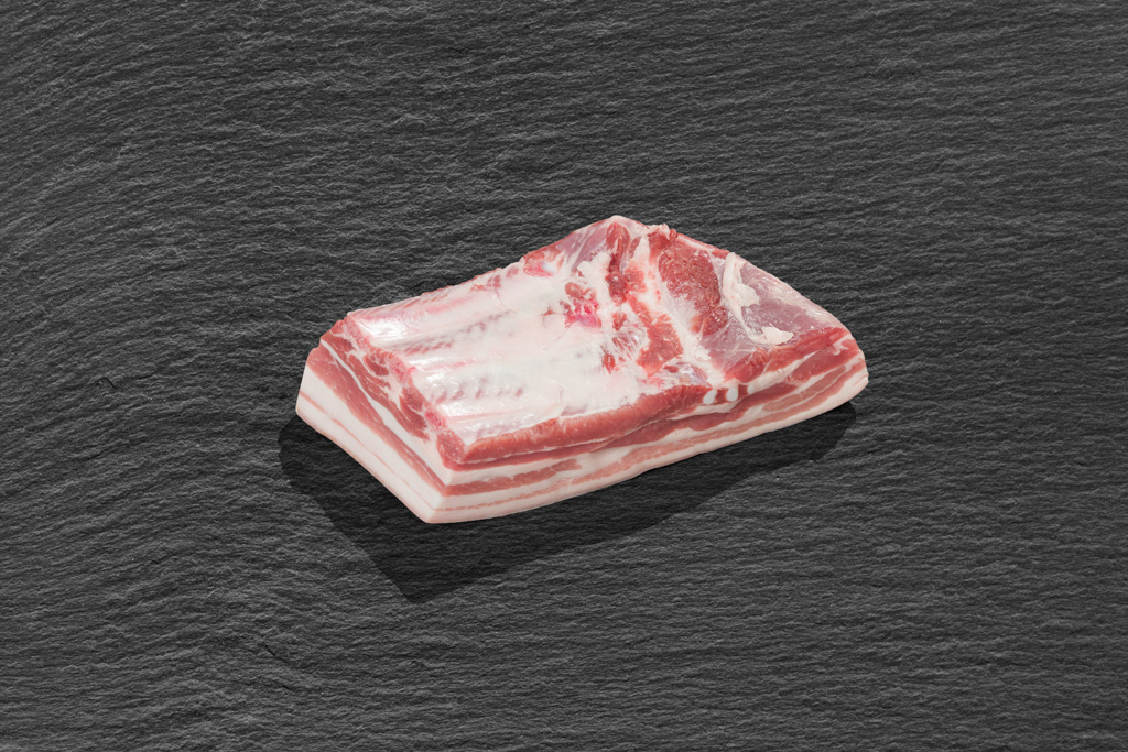 Bauch mit Schwarte unv Knochen vom Aktivstall-Schwein ein Stück Bauch mit Schwarte unv Knochen vom Aktivstall-Schwein
